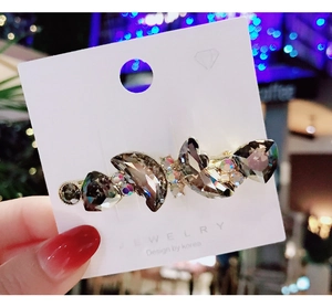 Detail of crystal butterfly hair clip with grey faceted stones and sparkling rhinestones