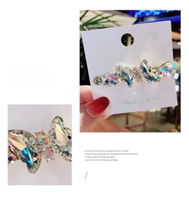 Macro detail of crystal butterfly hair clip with rhinestones on a display card