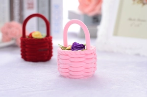 Close-up of pink and red velvet basket jewelry boxes with floral interior accents