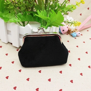 Detail of a black velvet coin purse with a silver metal kiss-lock closure clasp