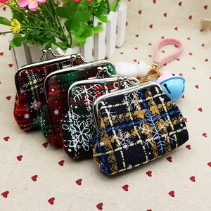 Detailed view of vintage plaid fabric coin purses with metal clasps and Christmas patterns