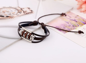Close-up of vintage multi-layer braided leather bracelet with beads and adjustable drawstrings
