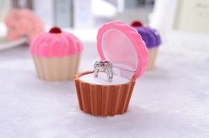 Macro view of cupcake-shaped velvet jewelry box for ring storage and display