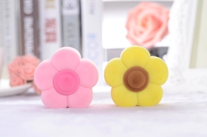 Detailed view of flower-shaped velvet jewelry boxes in soft pink and yellow colors