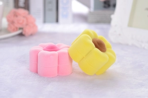 Close-up of pink and yellow floral velvet jewelry boxes on a white plush background