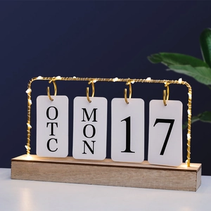 Minimalist wood desk calendar with warm LED lights and golden metal flip frame