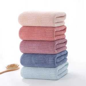Thick coral fleece bath towels with waffle pattern in five soft colors on white background