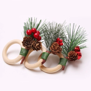 Detail of Christmas napkin rings with pine cones, red berries, and small jingle bells