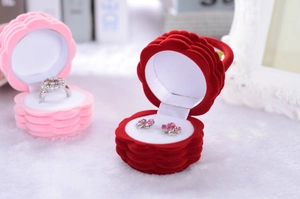 Detail showing red and pink rose velvet jewelry boxes for rings and earrings storage
