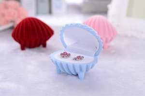Shell shaped velvet jewelry box in blue, red, and pink colors for earrings