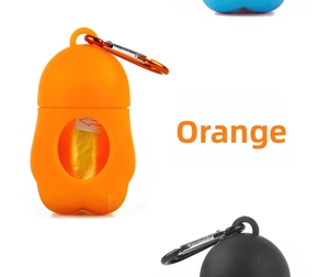 Detail of orange paw-shaped silicone waste bag dispenser with metal carabiner clip