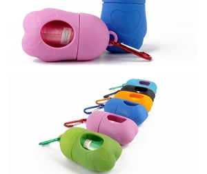 Close-up of paw-shaped pet waste bag dispenser with metal carabiner and refill roll