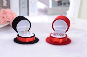 Detail of creative hat-shaped velvet jewelry boxes with ribbon for rings and earrings