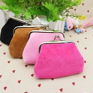 Detail of colorful velvet kiss-lock coin purses in black, brown, pink and rose red