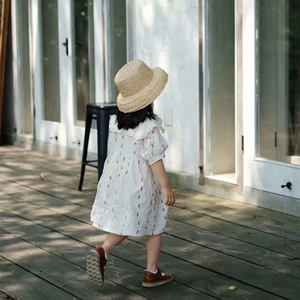 Close-up of a white floral dress for girls with puff sleeves and doll collar details