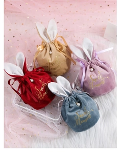 Detail of velvet bunny ear gift bags with pearl drawstring in multiple colors