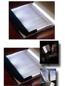 Detailed views of portable LED flat plate book light illuminating pages in the dark