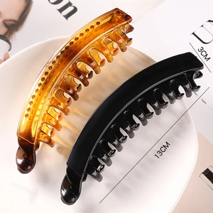 Detail view of 13cm minimalist hair banana clips in amber and black with size dimensions