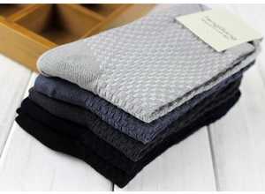 Close-up of bamboo fiber men's crew socks with waffle knit texture in assorted colors