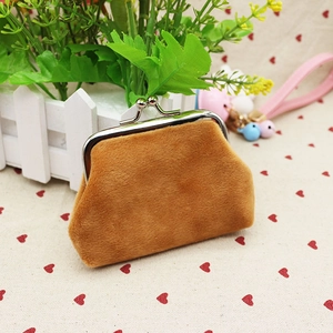 Detailed macro view of a brown plush coin purse with metal clasp and bell charms