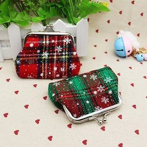 Detail view of mini Christmas coin purses with red and green plaid patterns and snowflakes