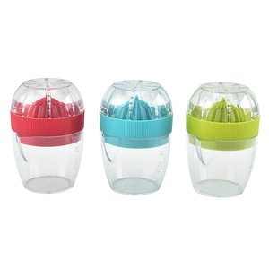 Three colorful manual plastic fruit juicers with transparent measuring cups in a row