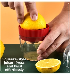Close-up of manual lemon squeezer with transparent cup showing citrus juicing process