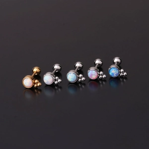 Macro view of opal cartilage studs with screw ball backs in gold and silver finishes
