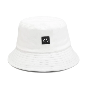 White cotton bucket hat with minimal smiley face embroidery for sun protection