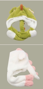 Detail of plush dinosaur hooded scarf with soft textures and cute 3D fin decorations