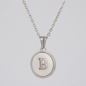 Close-up of letter B pendant with iridescent mother of pearl inlay on silver chain