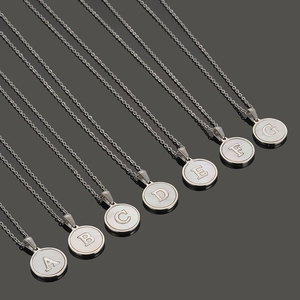 Collares con colgante redondo de acero inoxidable plateado con iniciales A-G fondo oscuro