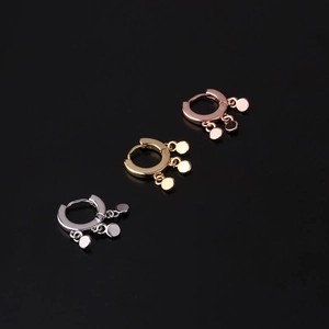 Detailed close-up of geometric hoop earrings in silver, gold, and rose gold finishes