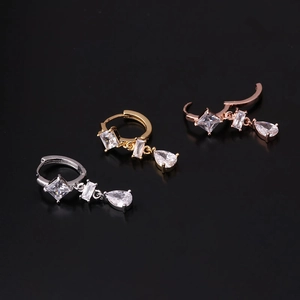 Geometric metallic earrings in silver, gold, and rose gold with zircon stone drops