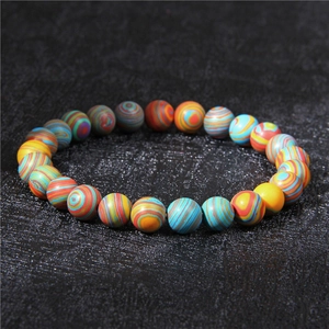 Close-up of 8mm natural white turquoise beads and colorful striped stone bracelet