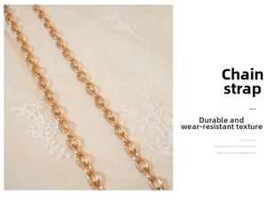 Detailed macro shot of the light gold metal chain strap on a star print crossbody bag