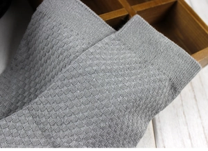 Close-up of grey bamboo fiber socks showing waffled knit texture and ribbed cuff