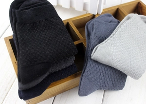 Close-up of bamboo fiber socks in waffle knit with elastic ribbed cuffs in storage box