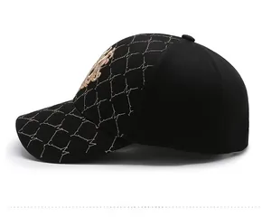 Close-up of luxury baseball cap with gold embroidery and crown emblem detail