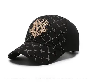 Detail view of black baseball cap with golden embroidery and diamond stitch patterns