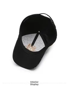 Interior view of black baseball cap showing golden embroidery on white lining