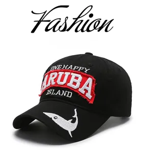 Close-up of black cotton baseball cap with red Aruba embroidery and white shark detail