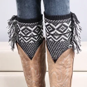 Bohemian knit leg warmers with black and white geometric patterns and side fringe details