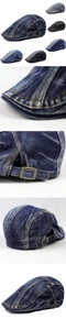 Detailed macro view of denim flat cap with vintage wash and side brass adjustment buckle