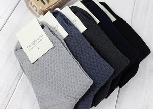 Close-up of bamboo fiber socks featuring checkered texture in varied gray and black tones