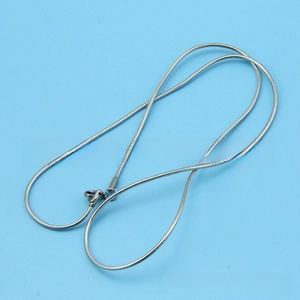 Macro detail of a silver snake chain necklace with a secure lobster clasp closure