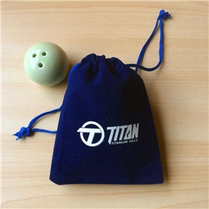 Blue velvet drawstring pouch with logo next to a light green ceramic nail tool holder