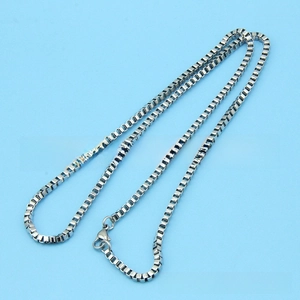 Detailed close-up of a silver stainless steel box chain necklace with a lobster clasp