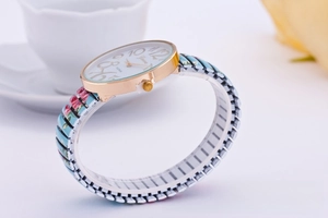 Detail of Geneva watch with floral print elastic metal strap and gold case
