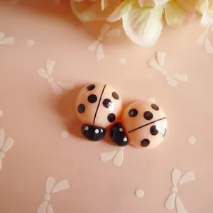 Macro detail of cute resin ladybug DIY accessory for hair clips and phone cases